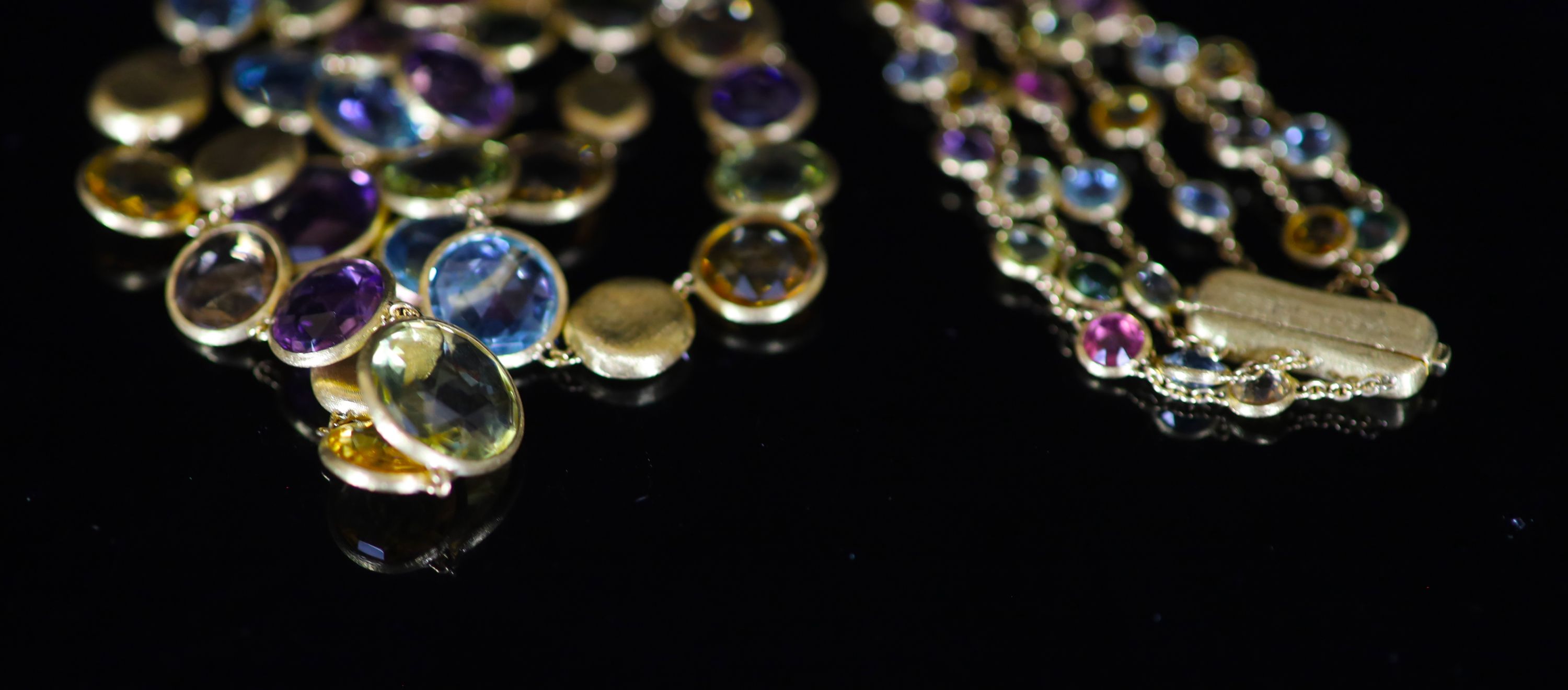 A modern Italian gold and graduated multi gem set three row spectacle necklace by Marco Bicego